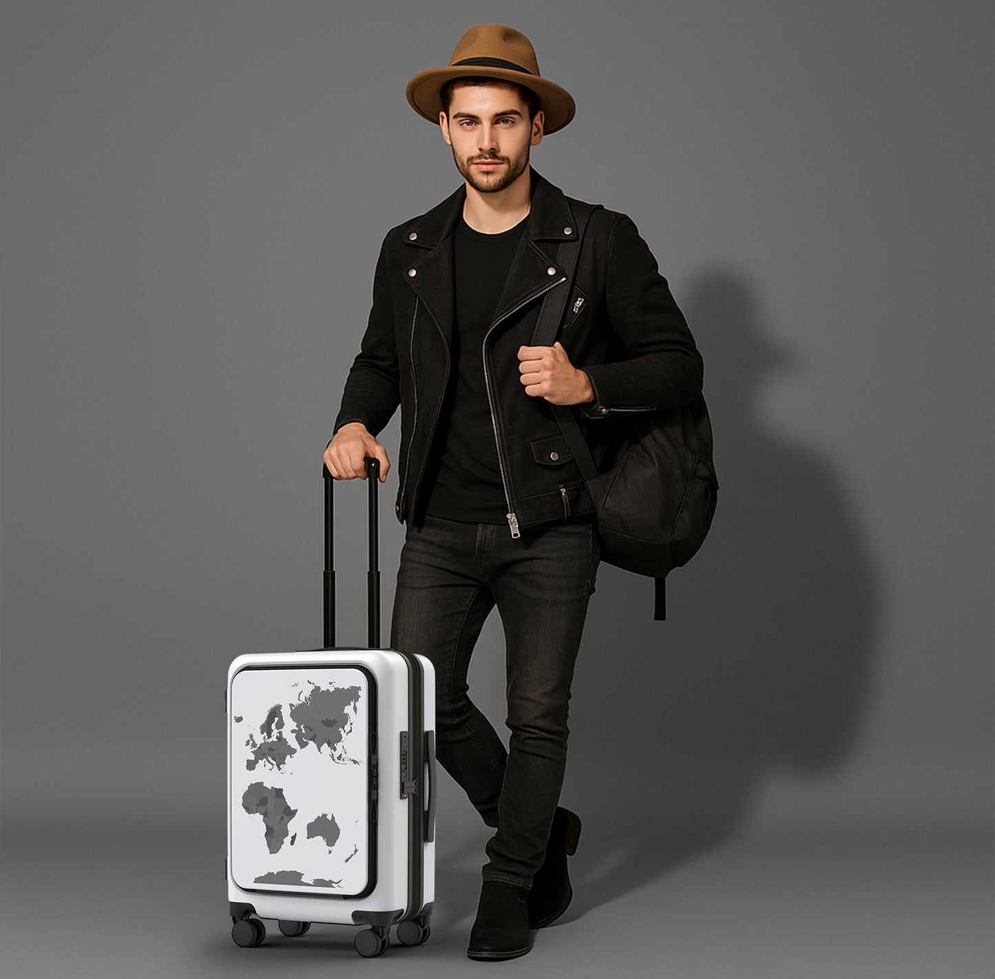 Man in black jacket and hat holding a white suitcase with world map design on a gray background